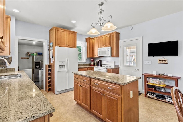 402 E Baird St, West Liberty, OH 43357 - kitchen with white appliances, light stone countertops, a kitchen island, pendant lighting, and light floors