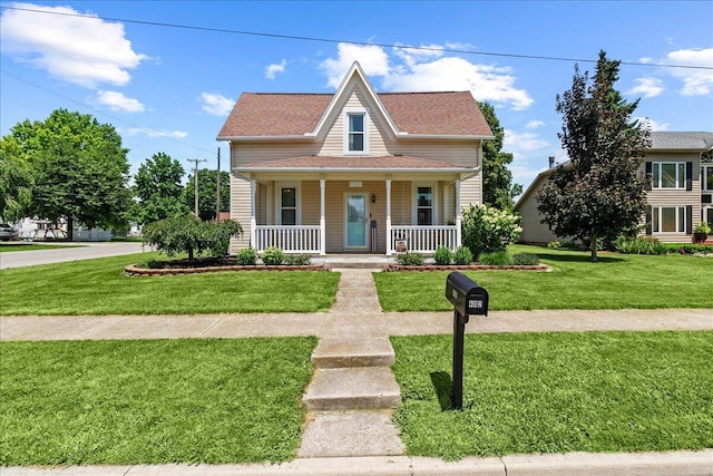 402 E Baird St, West Liberty, OH 43357 - bungalow-style home featuring a porch, a front lawn, and a shingled roof