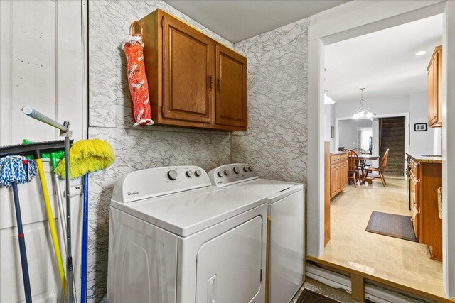 402 E Baird St, West Liberty, OH 43357 - washroom featuring cabinet space, independent washer and dryer, and a chandelier