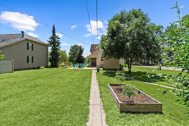 402 E Baird St, West Liberty, OH 43357 - view of green lawn featuring a garden and a patio area