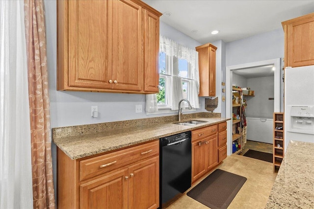 402 E Baird St, West Liberty, OH 43357 - kitchen with black dishwasher, light stone countertops, and brown cabinetry