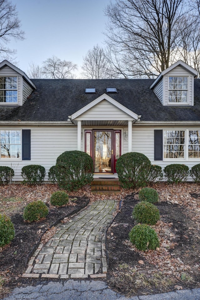 property entrance with a shingled roof