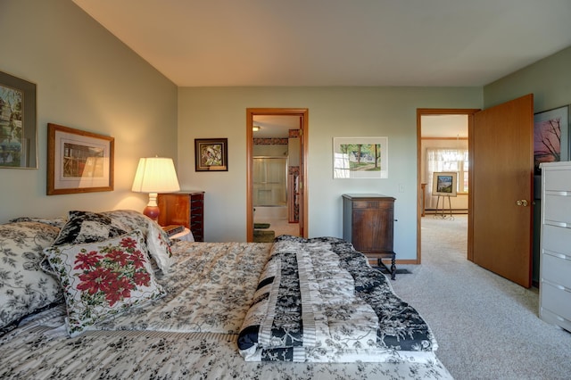 carpeted bedroom with connected bathroom and baseboards