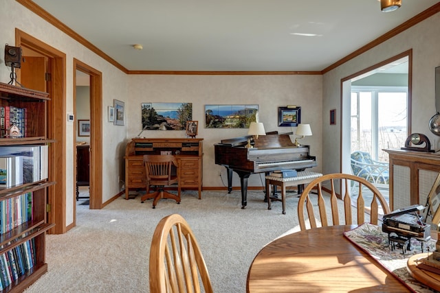 carpeted dining room featuring crown molding and baseboards