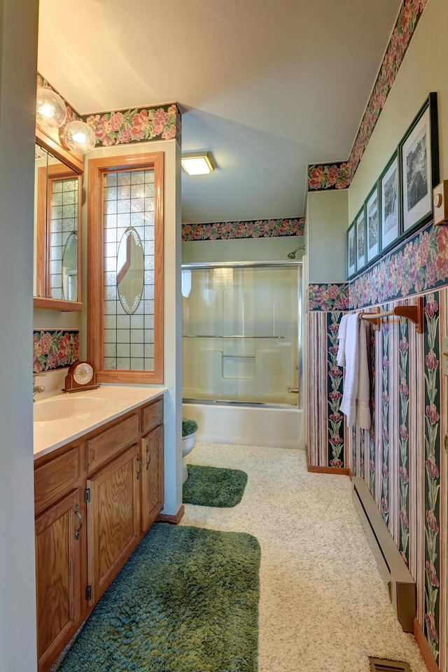 bathroom featuring toilet, shower / bath combination with glass door, wallpapered walls, a baseboard radiator, and vanity