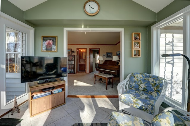 living room featuring vaulted ceiling, light tile patterned floors, and light carpet