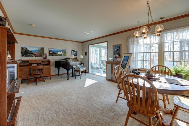 dining area featuring an inviting chandelier, crown molding, baseboards, and carpet floors