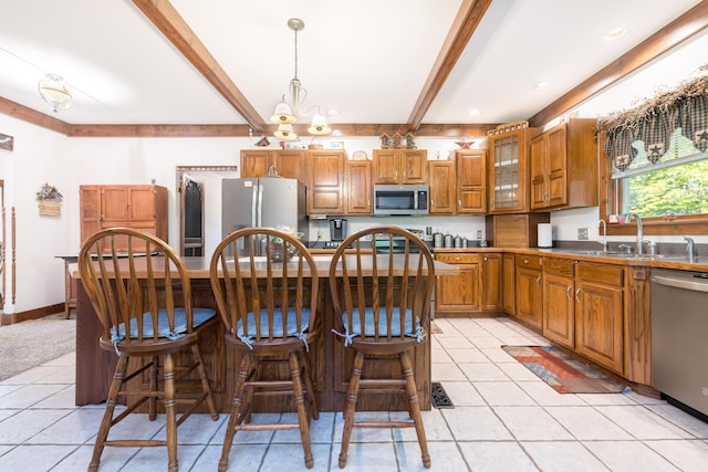 4602 State Route 273, Belle Center, OH 43310 - kitchen with appliances with stainless steel finishes, a sink, beam ceiling, light tile patterned floors, and brown cabinetry