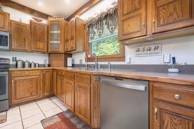 4602 State Route 273, Belle Center, OH 43310 - kitchen with appliances with stainless steel finishes, a sink, brown cabinets, light tile patterned floors, and glass insert cabinets