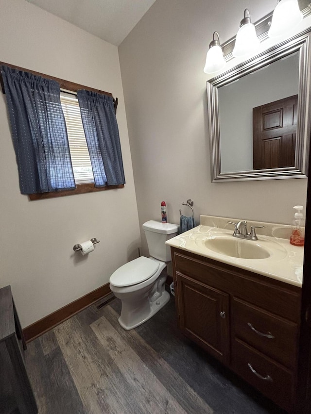 4602 State Route 273, Belle Center, OH 43310 - half bath with wood finished floors, vanity, toilet, and baseboards