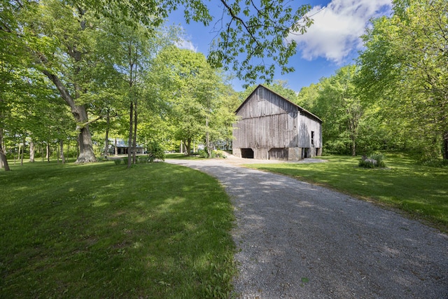 4602 State Route 273, Belle Center, OH 43310 - view of property exterior with a barn, a detached garage, a yard, and an outbuilding