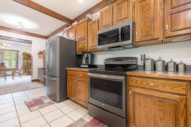 4602 State Route 273, Belle Center, OH 43310 - kitchen with stainless steel appliances, brown cabinets, light tile patterned floors, and beamed ceiling
