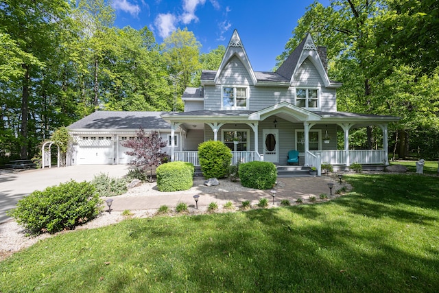 4602 State Route 273, Belle Center, OH 43310 - view of front of property with a porch, driveway, a front lawn, and a garage