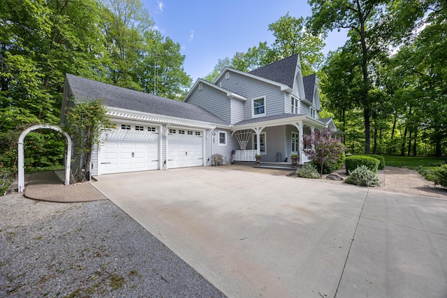 4602 State Route 273, Belle Center, OH 43310 - view of front of home with covered porch, a garage, a shingled roof, and driveway