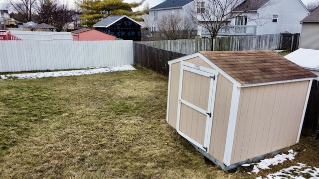 view of shed featuring a fenced backyard and a residential view