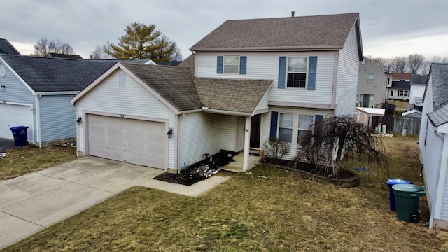 traditional-style house with a garage, driveway, a shingled roof, and a front yard