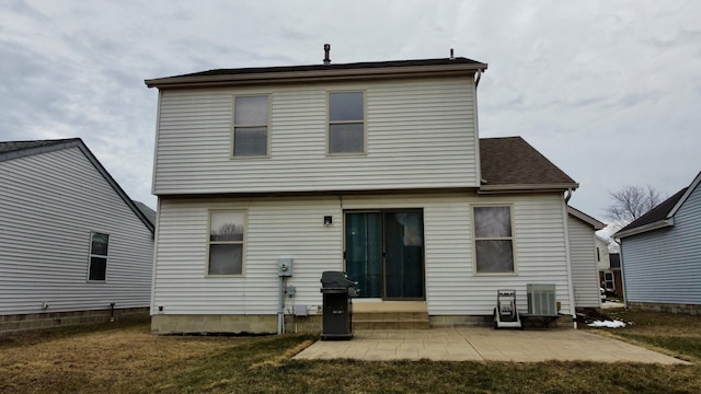 rear view of property featuring entry steps, a patio, and a yard