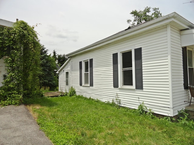 203 N Koke St, De Graff, OH 43318 - view of home's exterior featuring a yard