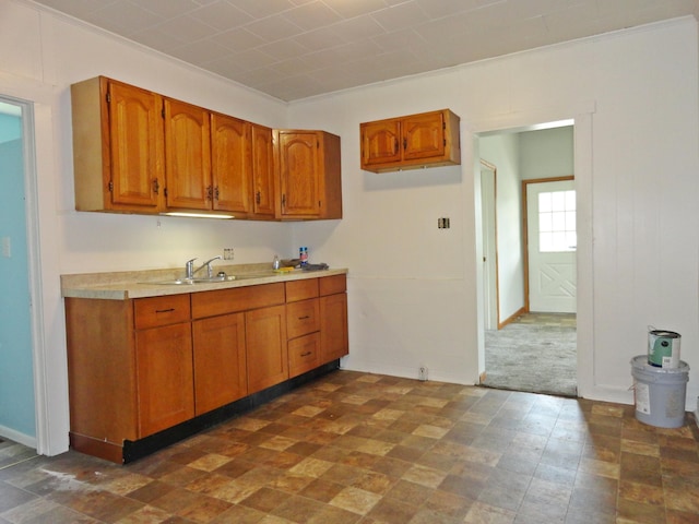 203 N Koke St, De Graff, OH 43318 - kitchen with light countertops, brown cabinetry, and crown molding