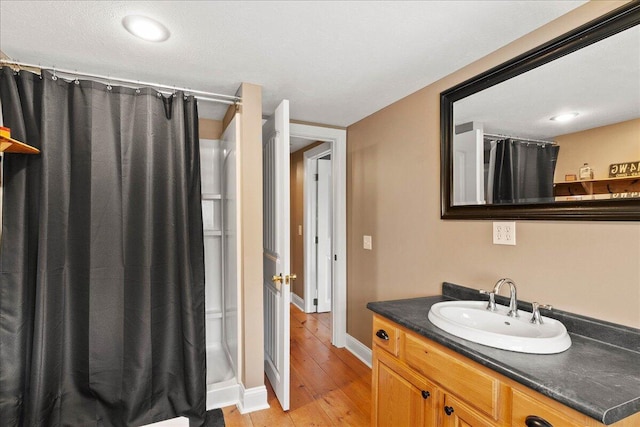 bathroom with vanity, hardwood / wood-style floors, and a shower with curtain