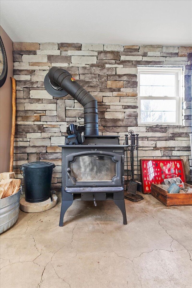 room details with concrete floors and a wood stove