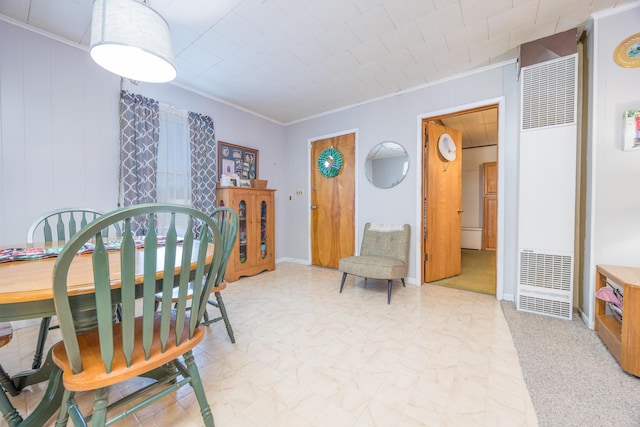 dining room featuring a heating unit, crown molding, and baseboards