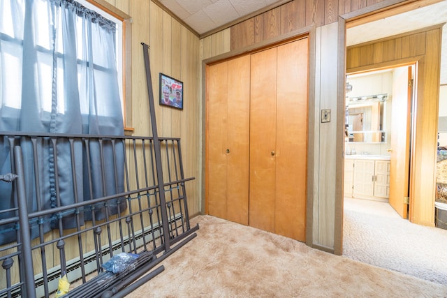 corridor featuring light carpet and wood walls