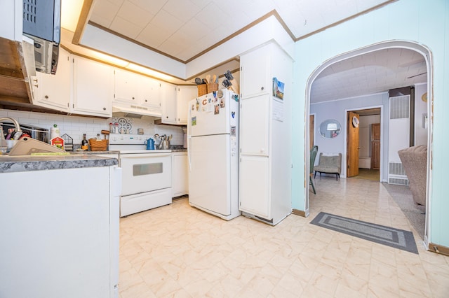 kitchen with arched walkways, crown molding, white cabinetry, white appliances, and under cabinet range hood