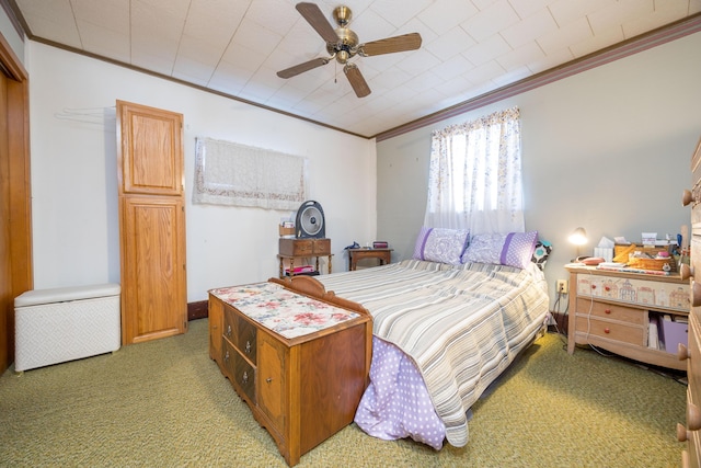 carpeted bedroom with ceiling fan and ornamental molding