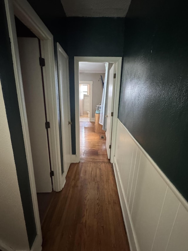 411 Middle St, Wapakoneta, OH 45895 - hall featuring dark wood-style floors, wainscoting, and baseboards