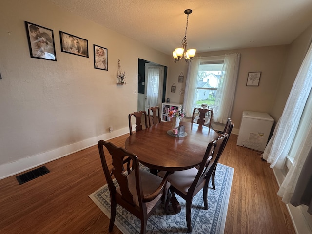 411 Middle St, Wapakoneta, OH 45895 - dining room with wood finished floors, baseboards, and a chandelier