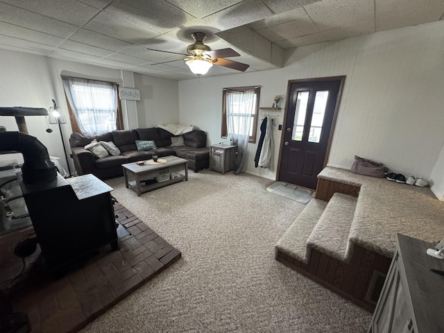 411 Middle St, Wapakoneta, OH 45895 - carpeted living area with a paneled ceiling, a wood stove, and ceiling fan
