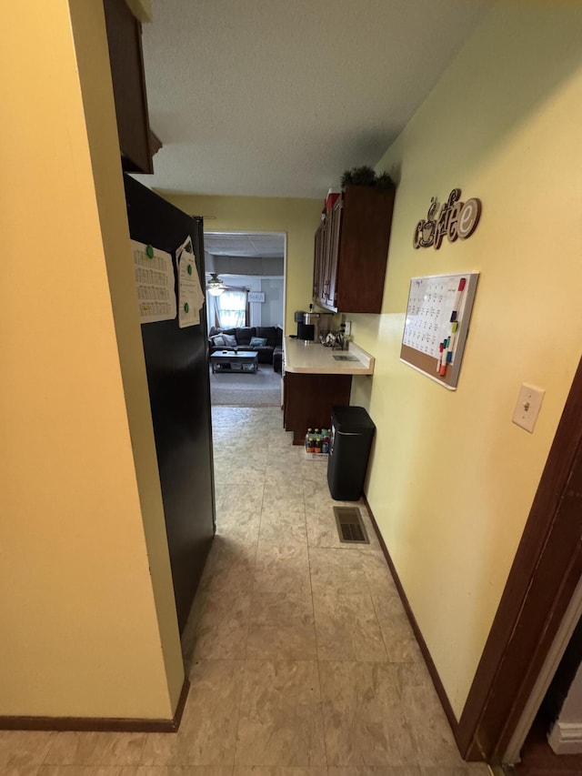 411 Middle St, Wapakoneta, OH 45895 - hallway with a textured ceiling, baseboards, and light tile patterned flooring