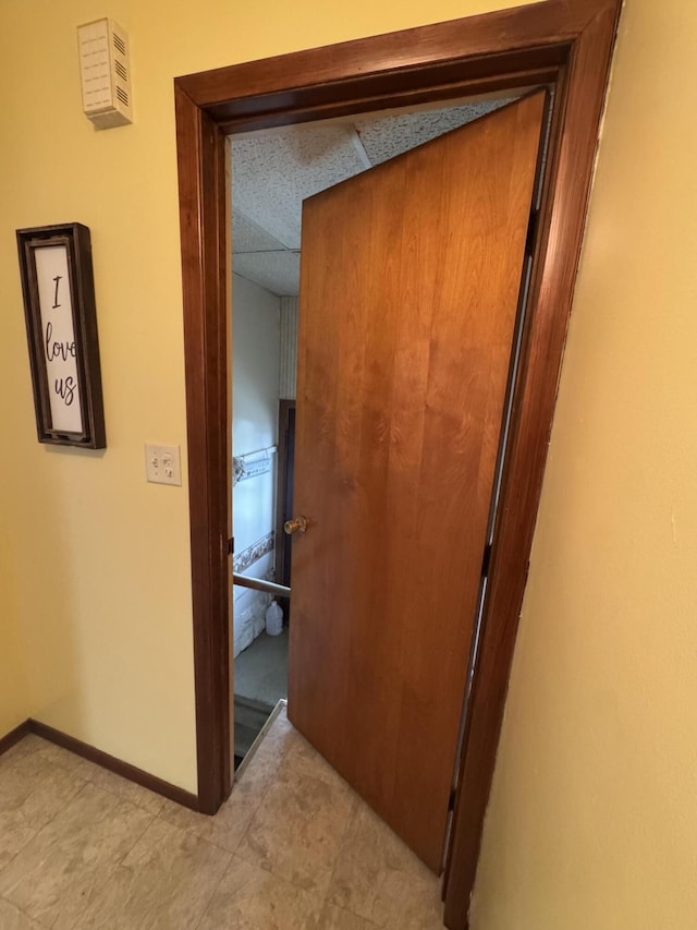411 Middle St, Wapakoneta, OH 45895 - hallway featuring a paneled ceiling and baseboards
