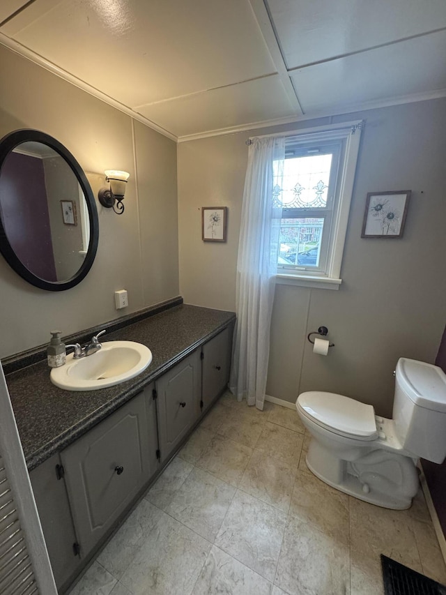 411 Middle St, Wapakoneta, OH 45895 - bathroom featuring toilet, vanity, and baseboards