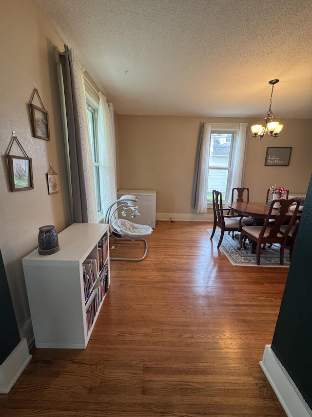 411 Middle St, Wapakoneta, OH 45895 - dining room with a textured ceiling, wood finished floors, baseboards, and a chandelier