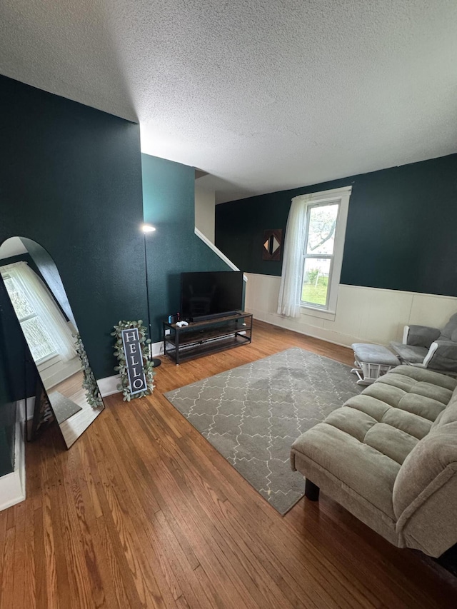 411 Middle St, Wapakoneta, OH 45895 - living room featuring a textured ceiling, wood finished floors, and wainscoting
