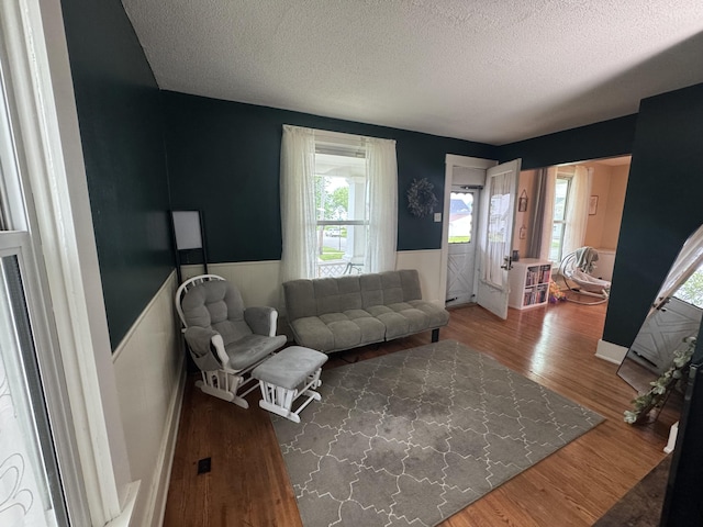 411 Middle St, Wapakoneta, OH 45895 - living room with a wainscoted wall, a textured ceiling, and wood finished floors