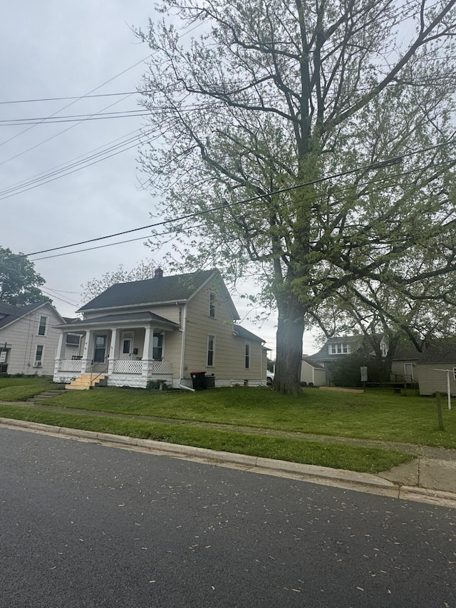 411 Middle St, Wapakoneta, OH 45895 - view of front of property featuring a porch, a front lawn, and a chimney