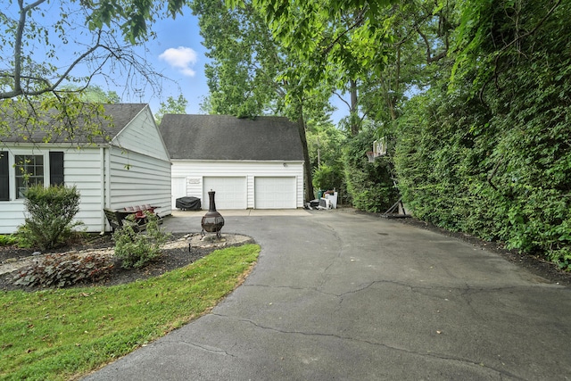 650 Swailes Rd, Troy, OH 45373 - view of home's exterior with an outdoor structure and roof with shingles