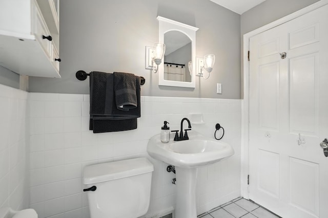 650 Swailes Rd, Troy, OH 45373 - bathroom with tile walls, tile patterned floors, and wainscoting