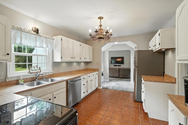 650 Swailes Rd, Troy, OH 45373 - kitchen with appliances with stainless steel finishes, white cabinetry, a chandelier, dark tile patterned floors, and decorative light fixtures