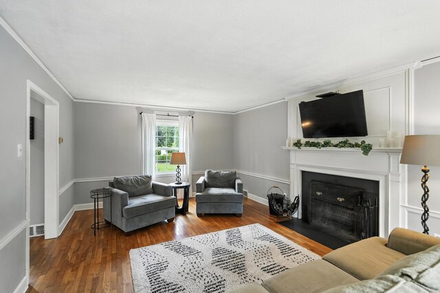 650 Swailes Rd, Troy, OH 45373 - living area featuring wood finished floors, a fireplace with flush hearth, and ornamental molding