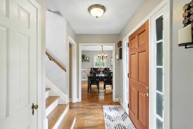 650 Swailes Rd, Troy, OH 45373 - entrance foyer with a chandelier, light wood-style flooring, and stairs