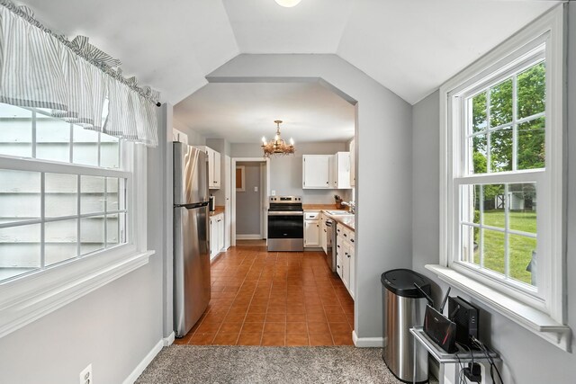 650 Swailes Rd, Troy, OH 45373 - kitchen with a chandelier, plenty of natural light, appliances with stainless steel finishes, white cabinets, and vaulted ceiling