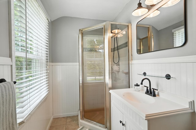 650 Swailes Rd, Troy, OH 45373 - bathroom with wainscoting, a shower stall, vaulted ceiling, tile patterned floors, and healthy amount of natural light