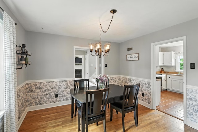 650 Swailes Rd, Troy, OH 45373 - dining room with light wood finished floors and a chandelier