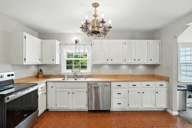 650 Swailes Rd, Troy, OH 45373 - kitchen with appliances with stainless steel finishes, a chandelier, white cabinetry, tile patterned floors, and light countertops