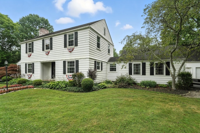 650 Swailes Rd, Troy, OH 45373 - colonial house with a front lawn, a chimney, and a garage