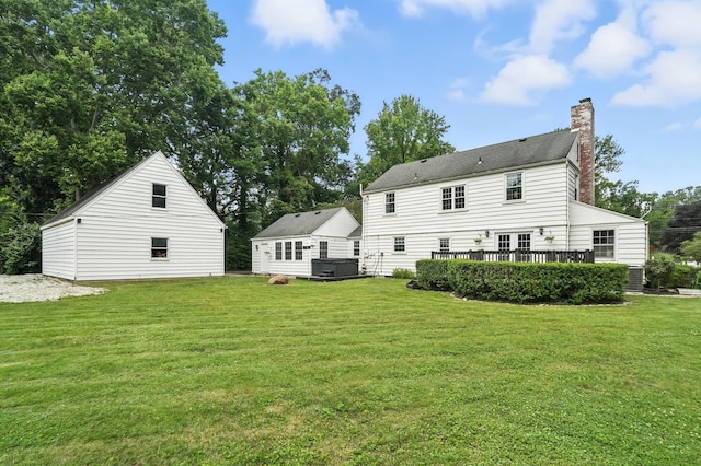 650 Swailes Rd, Troy, OH 45373 - rear view of house featuring a chimney, a lawn, and a deck
